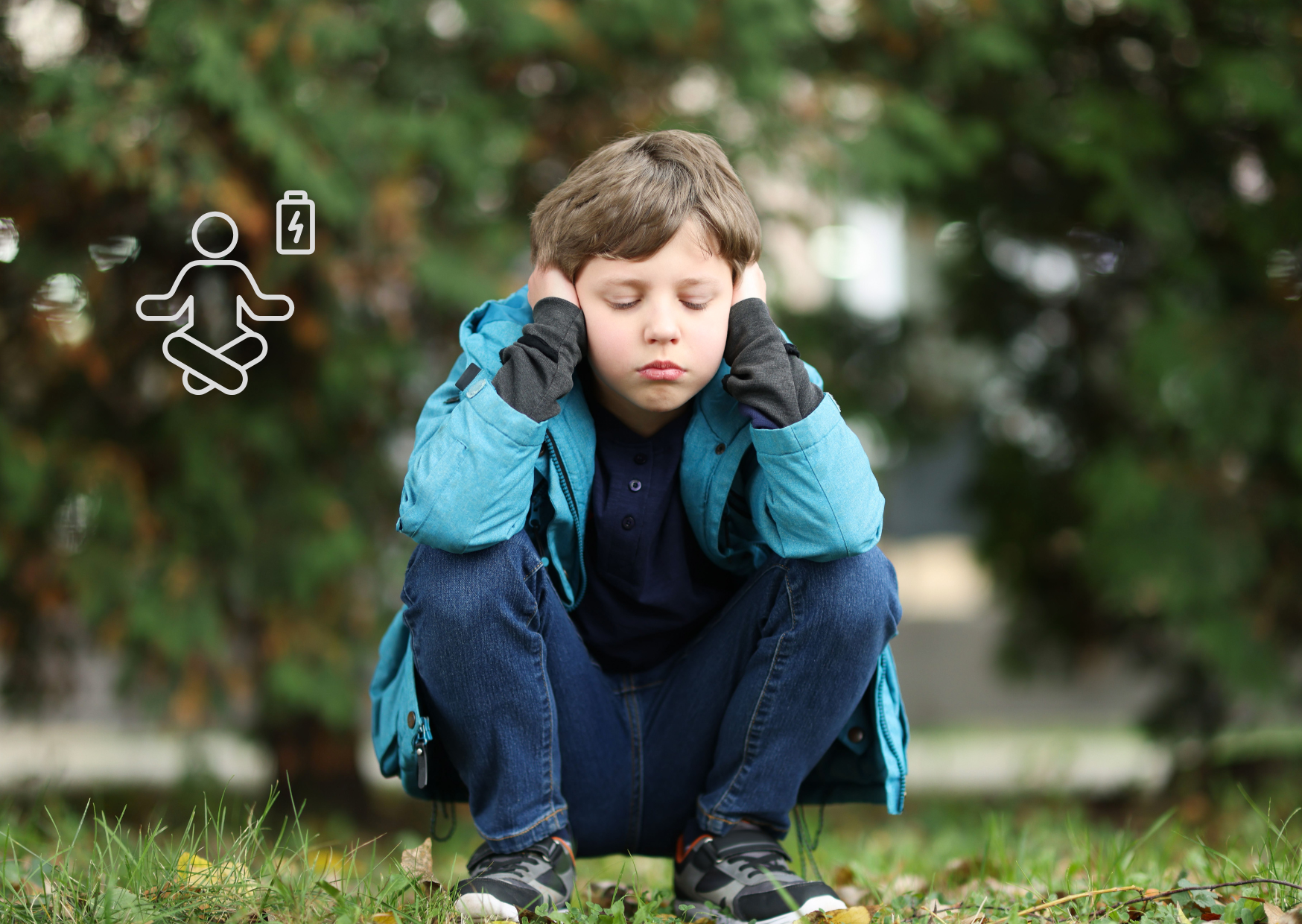 kind gehurkt op de grond met handen op de oren