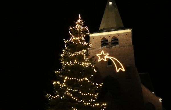 kerstboom op het plein en vallende ster aan de kerk van Gooreind