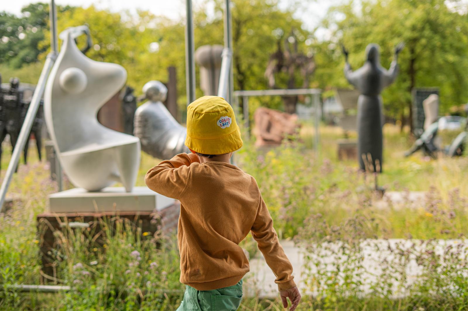 Een kind wandelt tussen de beelden in het Middelheimmusem