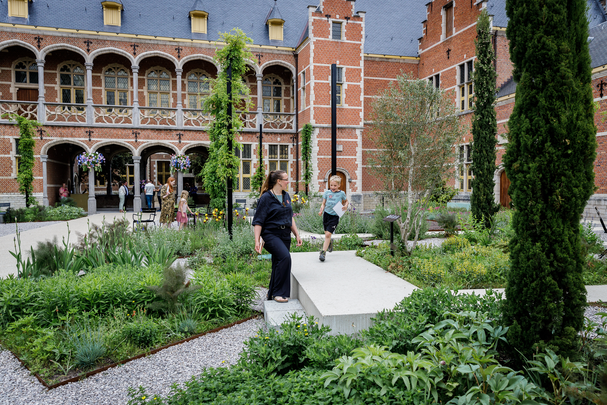 foto van museum hof van busleyden in de tuin met drie personen