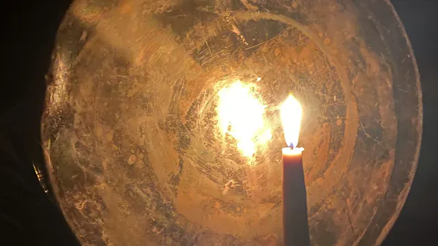 Brandende kaars met reflector