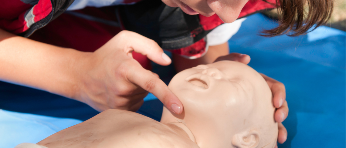 Volwassenen voert reanimatie uit op een kinderpop