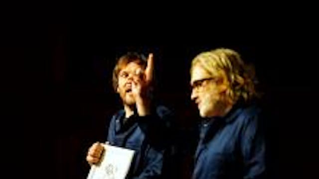 Afbeelding van 2 mensen die naast elkaar zitten en met elkaar praten.